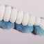 Close-up of the HuggleHounds X-Brace Calamaro Large Dog Tots, an interactive spiral dog toy by HuggleHounds, featuring alternating blue and white fluffy textures against a plain light background.