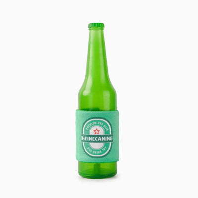 The Hugsmart Pet Boozy Tailz Heinecanine Tpr Rubber Dog Toy by Hugsmart Pet is a green rubber dog toy with a turquoise “Heinecanine Premium Dog Beer” sleeve, red star, and “Dog Drink Toy” text, shown on a plain white background. Ideal for interactive play.