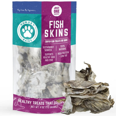 A 4 oz bag of Hungry Paws Premium Cod Skin Dog Chew Treats stands upright with dried fish skins beside it. The packaging spotlights these natural, high-protein treats as rich in omega-3 for healthy skin and coats.