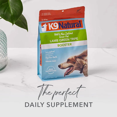 A bag of K9 Natural Beef Green Tripe Booster Digestive Supplement for Dogs sits on a white marble surface beside a green plant. The caption reads: The perfect daily supplement made with New Zealand grass-fed beef from K9 Natural.