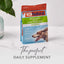 A bag of K9 Natural Lamb Green Tripe Booster Digestive Supplement for Dogs sits on a white marble surface by a green plant, with the words The perfect daily supplement displayed below.