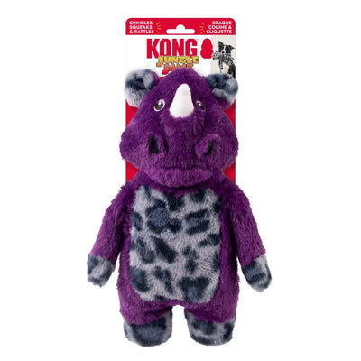 The KONG Jungle Jamz Rhino Dog Toy by Kong features a plush purple and gray rhino with a white horn, black spots, crinkly texture, and durable squeaker, displayed in red and yellow branded packaging.