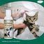 A person bathes a surprised cat in a sink, white foam from Mad About Organics Cat Oatmeal Shampoo on its head. In front is a 4oz bottle labeled Gentle Care for Happy Skin by Mad About Organics.