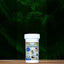 A container of Mad About Organics Oral Care Powder for Pets by Mad About Organics rests on a wooden surface with green ferns behind it. The label shows a dog and features blue and beige accents.