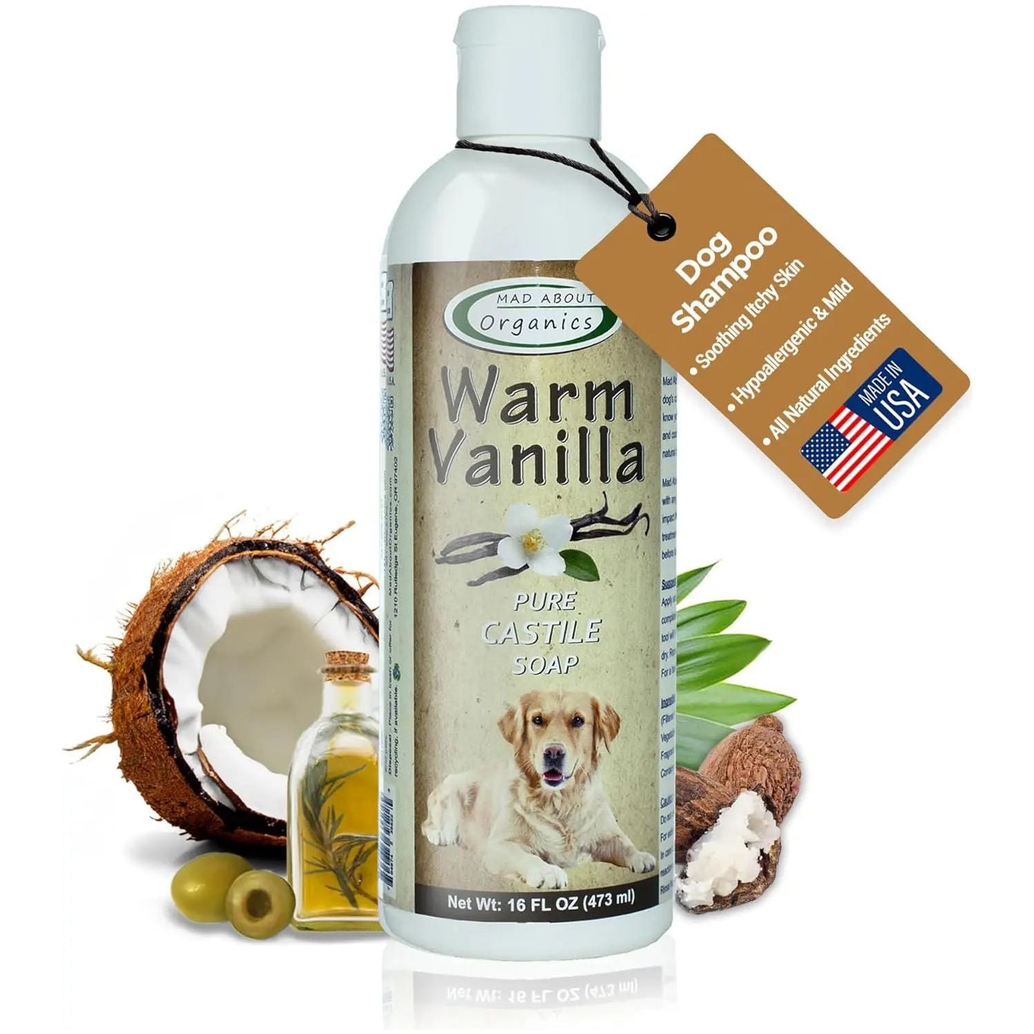 A 16oz bottle of Mad About Organics Warm Vanilla Dog Shampoo, featuring images of a dog, vanilla flower, coconut, aloe vera, and olives; a tag notes its soothing organic formula for sensitive skin and quality USA-made ingredients.