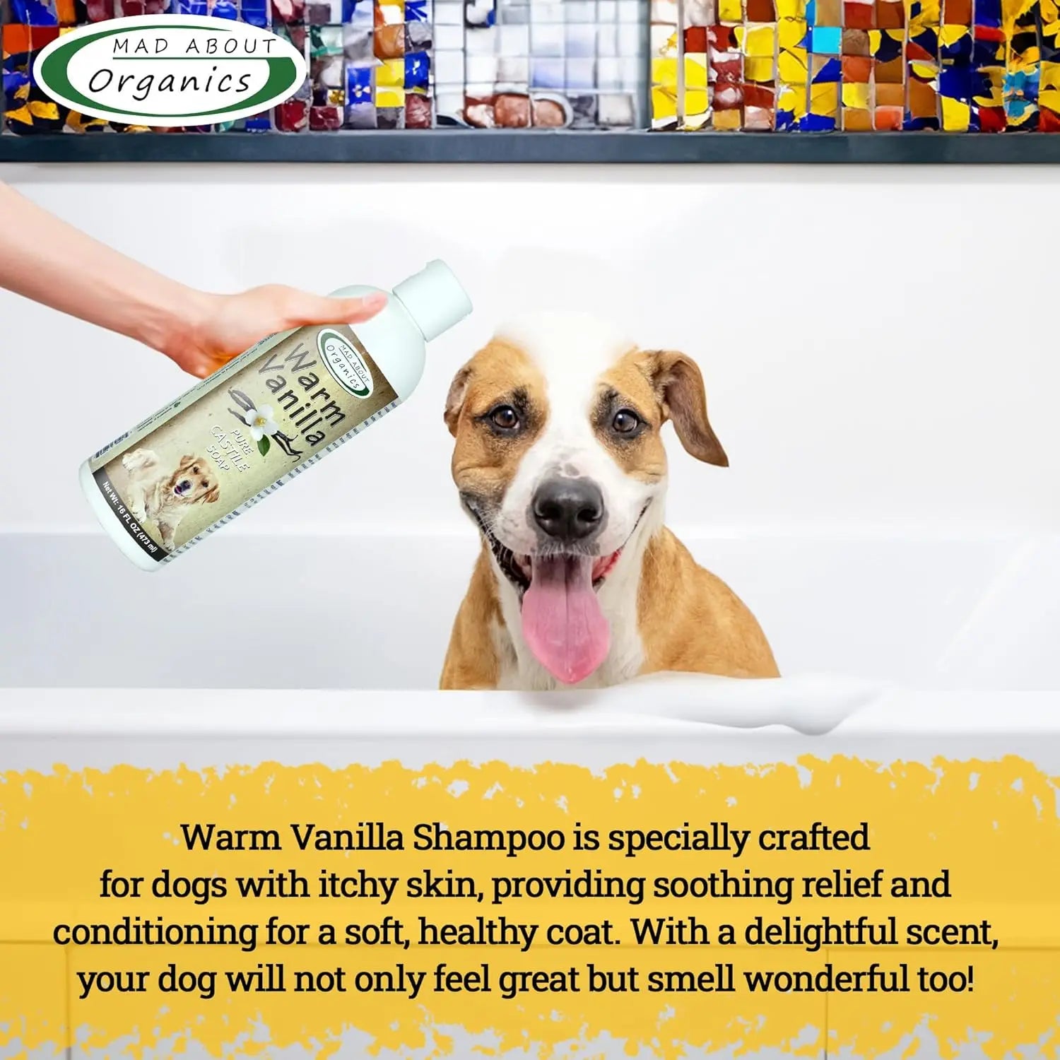 A brown and white dog sits in a bathtub, panting happily as a hand holds Mad About Organics Warm Vanilla Dog Shampoo 16oz. Text below highlights the soothing, warm vanilla scent for sensitive skin by Mad About Organics.
