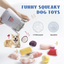 A corgi lounges next to the Nocciola 10-Piece Seafood Boil Dog Toy Set, featuring food-shaped plush toys with squeakers and crinkle sounds. A hand reveals the soft container labeled funny squeaky dog toys.