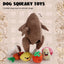 Nocciola Colorful Turkey-Themed Dog Toys for puppies and small breeds include a brown turkey, mushroom, carrot, strawberry, lemon, potato, and a pink striped ball with smiling faces on a beige doodle-patterned background.