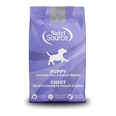 A 5 lb purple bag of NutriSource Choice Chicken Meal & Barley Recipe Puppy Dry Dog Food features a white puppy silhouette, grain-inclusive formula, bilingual English and French labeling, and benefit icons at the bottom.
