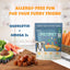 A bag of PETIPET Allergy + Immunity with Quercetin & Omega 3 Apple & Carrot Flavored Soft Chew Dog Supplement sits on a kitchen counter with treats, fruits, and veggies. Text highlights allergy-free fun and natural immunity support.