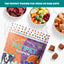 Top-down view of PETIPET Pumpkin Fruit + Veggie Bites Gluten-Free Adult Soft & Chewy Dog Treats 5oz on marble, surrounded by small bowls of raw meat, fruits, and veggies. Perfect with fresh or raw diets—made with human-grade ingredients.