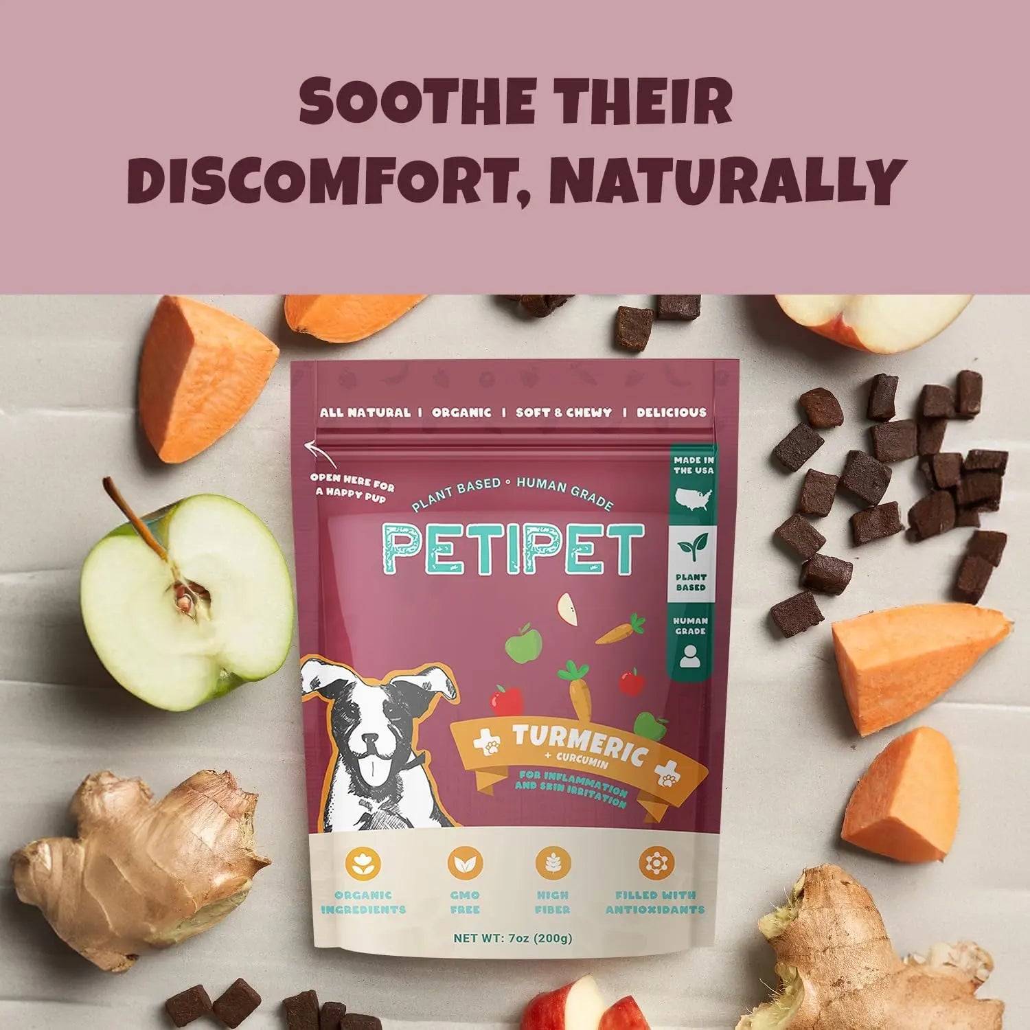 A bag of PETIPET Turmeric Bites + Curcumin Apple & Carrot Soft Chew Anti-Inflammatory Supplement for Dogs 7oz is surrounded by apple slices, ginger, and turmeric. The packaging highlights organic, plant-based ingredients and curcumin for relief. Text: Soothe Their Discomfort, Naturally.