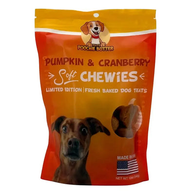 A 12oz bag of Poochie Butter Dillys Pumpkin Soft & Chewy Dog Treats with orange packaging, a dog photo, a clear window displaying the treats, and labels showing limited edition, fresh baked, and made in the USA.