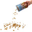 A hand pours Poochie Butter Peanut Butter Crunchy Dog Treats, 8oz, from a blue Poochie Butter bag onto a white surface, scattering the small brown treats.