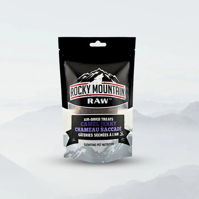 A stand-up pouch of Rocky Mountain Raw Premium Allergy-Friendly Camel Jerky for Dogs 1.76 oz, labeled in English and French, features a misty mountain background and highlights allergy-friendly protein with a resealable top.