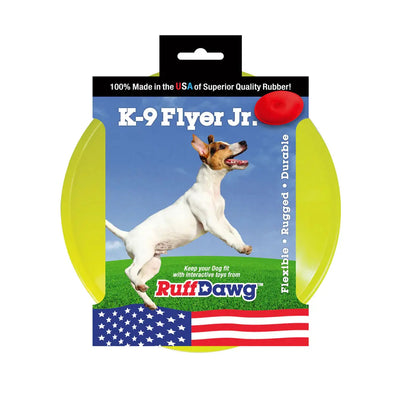Packaging for the Ruff Dawg K9 Flyer Disc Tough Dog Toy shows a dog catching a red disc on grass, features the Ruff Dawg brand, a USA flag, and highlights its flexibility, ruggedness, and long-lasting durability.