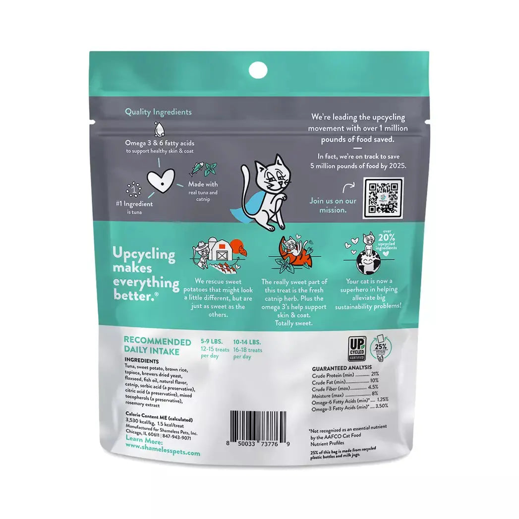 The back of Shameless Pets Fintastic Catnip Crunchy Cat Treats 2.5oz shows a turquoise and white design, cartoon cat, feeding instructions, QR codes, omega info, upcycling details, and a goal to upcycle 5 million pounds of food by 2025.