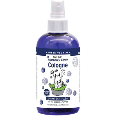 Showseason South Bark Blueberry Clove Dog Cologne is a blue spray bottle for pet grooming, made with non-toxic ingredients. The label shows a cartoon dog in a green bathtub with playful blueberry and clove illustrations.