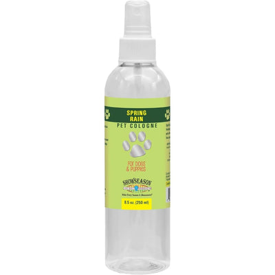 Showseason Spring Rain Dog Cologne for dogs & puppies, 8.5 oz (250 ml), has a clear spray bottle with a green and yellow label featuring white paw prints—cruelty-free and gives your pet a fresh fragrance.