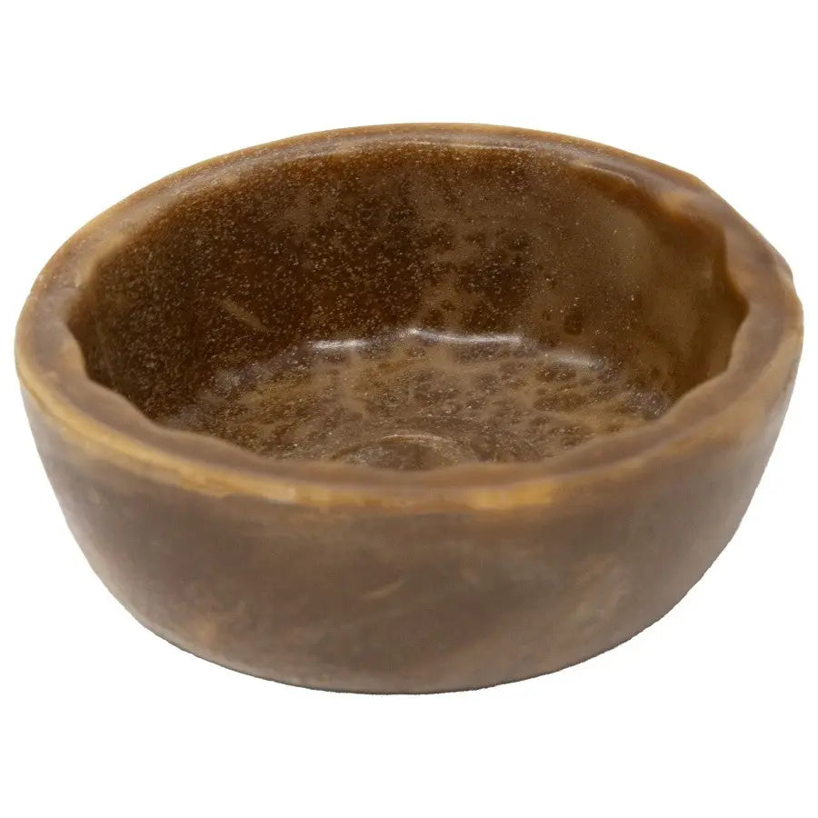 The Starmark® Starmark Dental Treat Cookie Cup Dog Treat is a small, round, brown bowl with a glossy finish and uneven rim. Made of solid, wax-like material, it provides your pet with a durable and enjoyable chew.