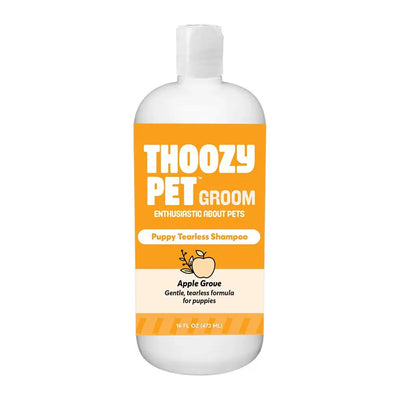 A 16oz white bottle of ThoozyPet Puppy Tearless Shampoo Apple Grove features an orange and white label with an apple image, highlighting its gentle, tearless formula and fresh apple scent for puppies.