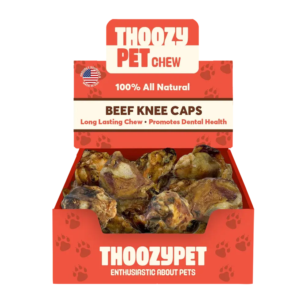 A ThoozyPet box labeled USA-Sourced Beef Knee Cap Bone Dog Chews 25ct shows several 100% all natural, long-lasting dog chews that promote dental health. Paw prints decorate the box.