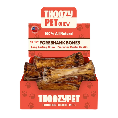 A red box labeled ThoozyPet contains 12 USA-sourced Foreshank Bone Dog Chews (10-12). The packaging promotes them as 100% all natural, great for dental health, and features an American flag in the corner.