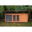 A Zoo Med Laboratories Easy-Fold Tortoise Terrarium Yard door with mesh panels sits on grass—perfect for outdoor tortoise enclosures—set before a wire fence and green plants.