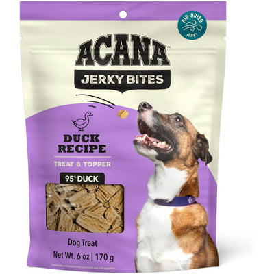 ACANA duck jerky dog treats in a bag with a happy dog looking up at the product