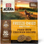 Acana freeze-dried dog food topper with chicken recipe in a nature setting with a dog