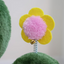 Colorful flower attachment on a cactus cat scratching post with soft textures for playful cats
