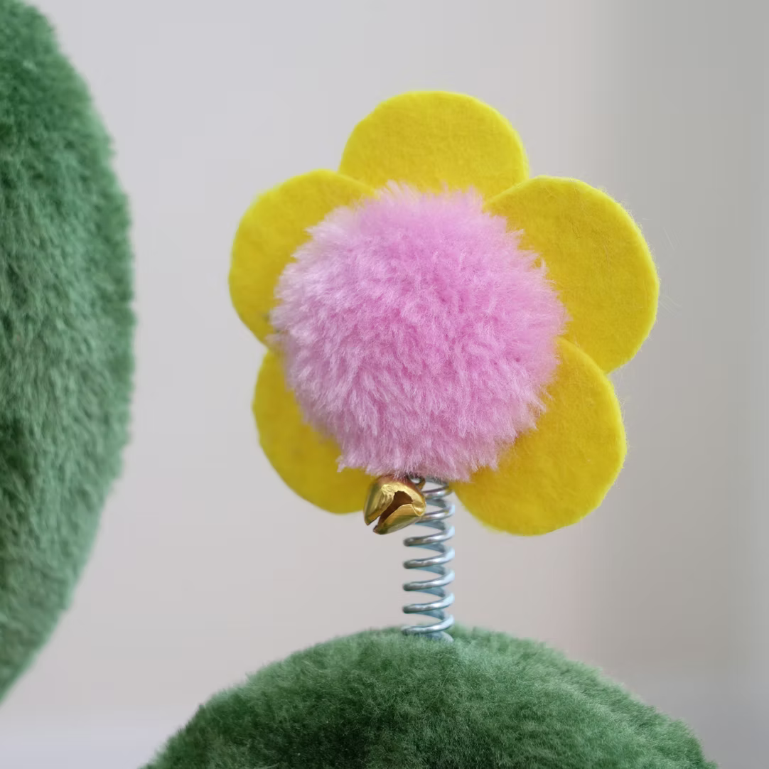 Colorful flower attachment on a cactus cat scratching post with soft textures for playful cats
