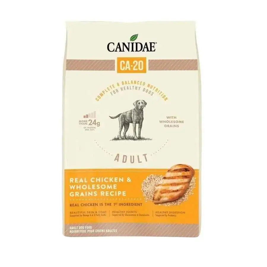 A beige and orange bag of CANIDAE CA-20 Real Chicken Recipe with Wholesome Grains Dry Dog Food is shown, featuring a dog illustration and images of grilled chicken and grains.