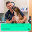 Veterinarian with a dog enjoying Get Joy beef kidney freeze dried dog treats, promoting healthy snacking