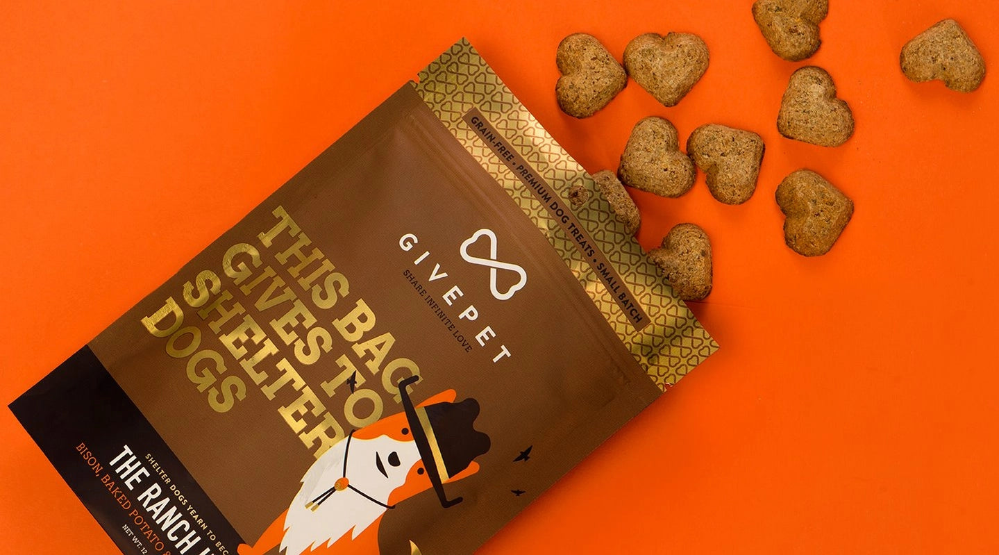 GivePet grain free baked dog biscuits in heart shapes on an orange background