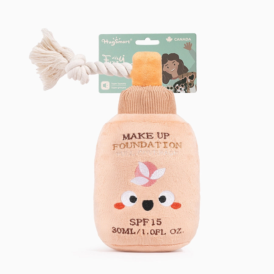 Hugsmart Pet makeup plush dog toy designed as a foundation bottle with a cute face and rope tail