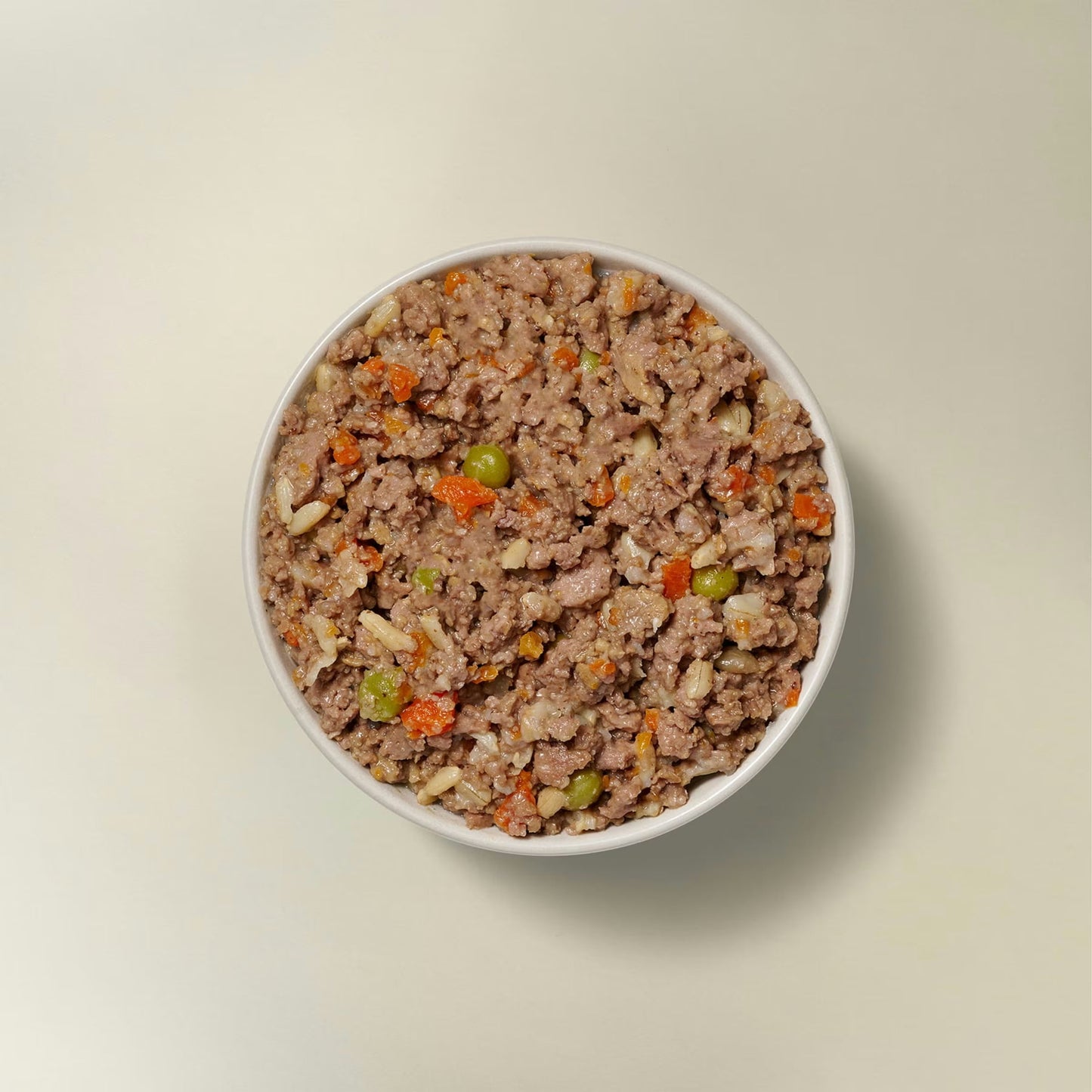 Now Fresh chicken and rice wet dog food in a bowl with peas and carrots for healthy dog meals