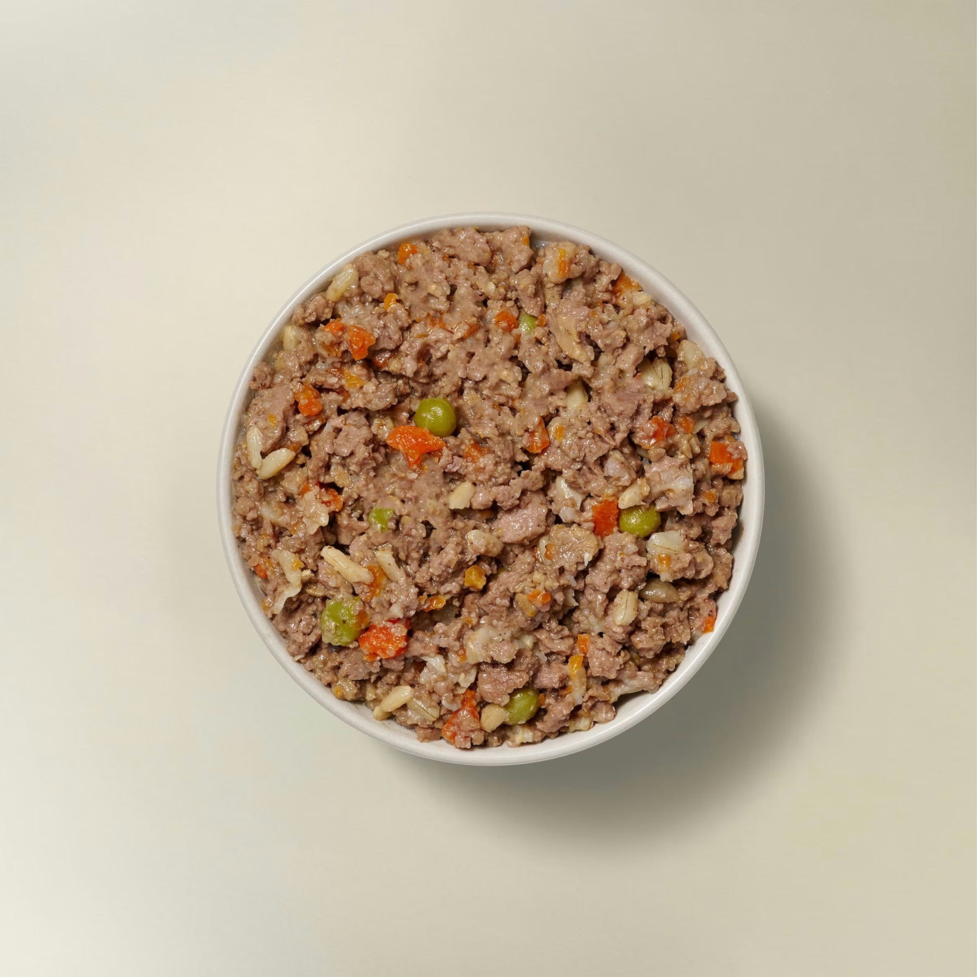 Now Fresh chicken and rice wet dog food in a bowl with peas and carrots for healthy dog meals