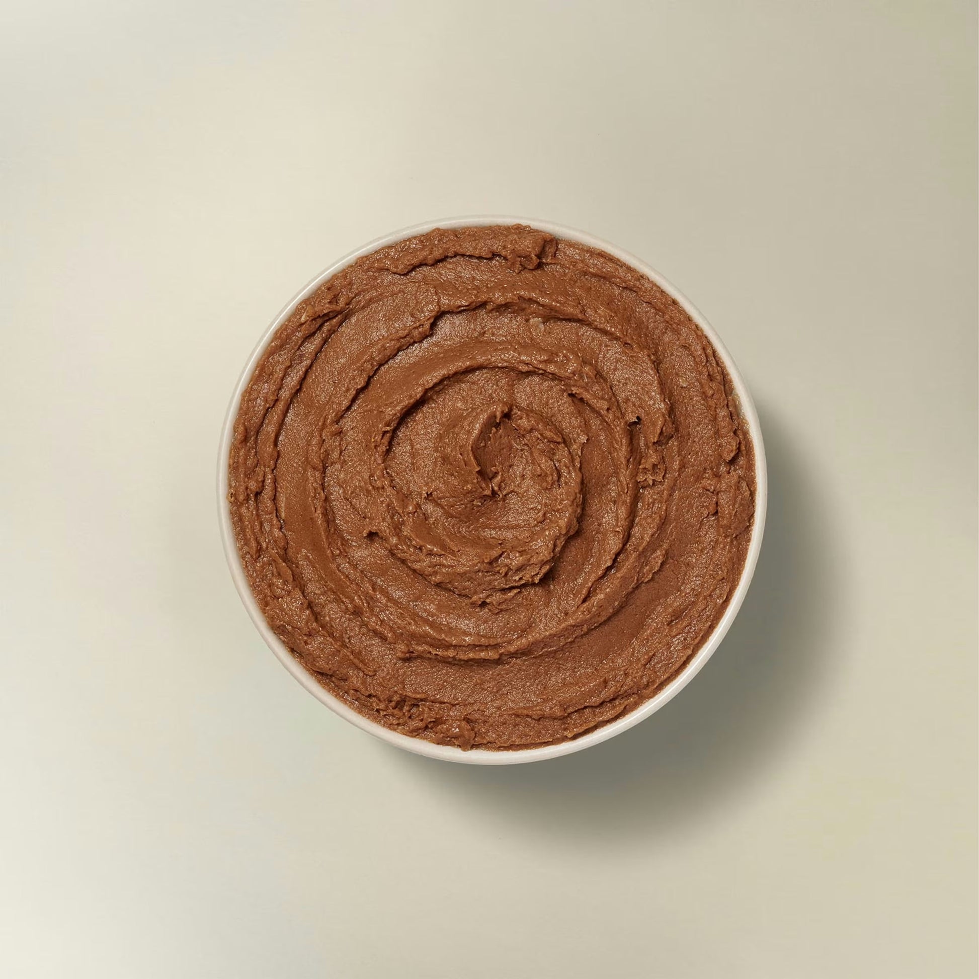 Petcurean grain free senior wet cat food in a bowl, showcasing a smooth and rich texture