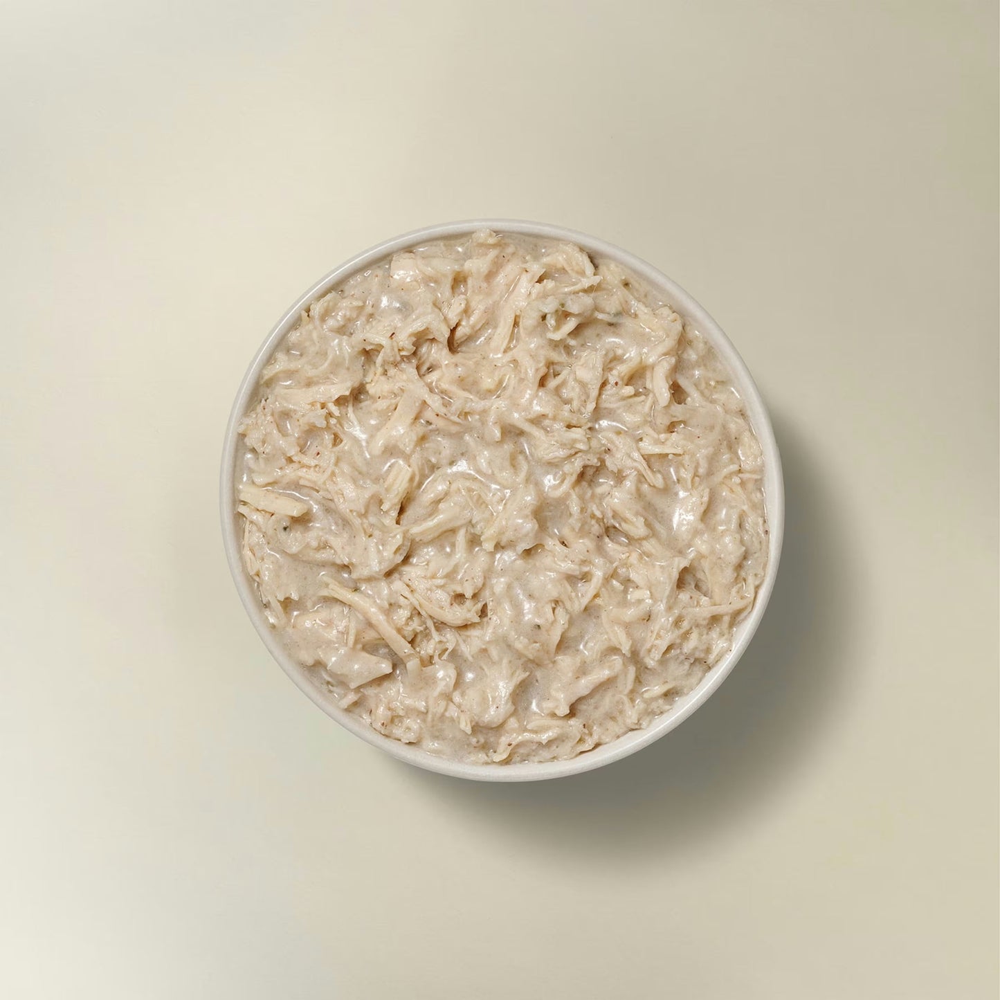 Petcurean grain free wet dog food for small breeds in a bowl with moist turkey chunks