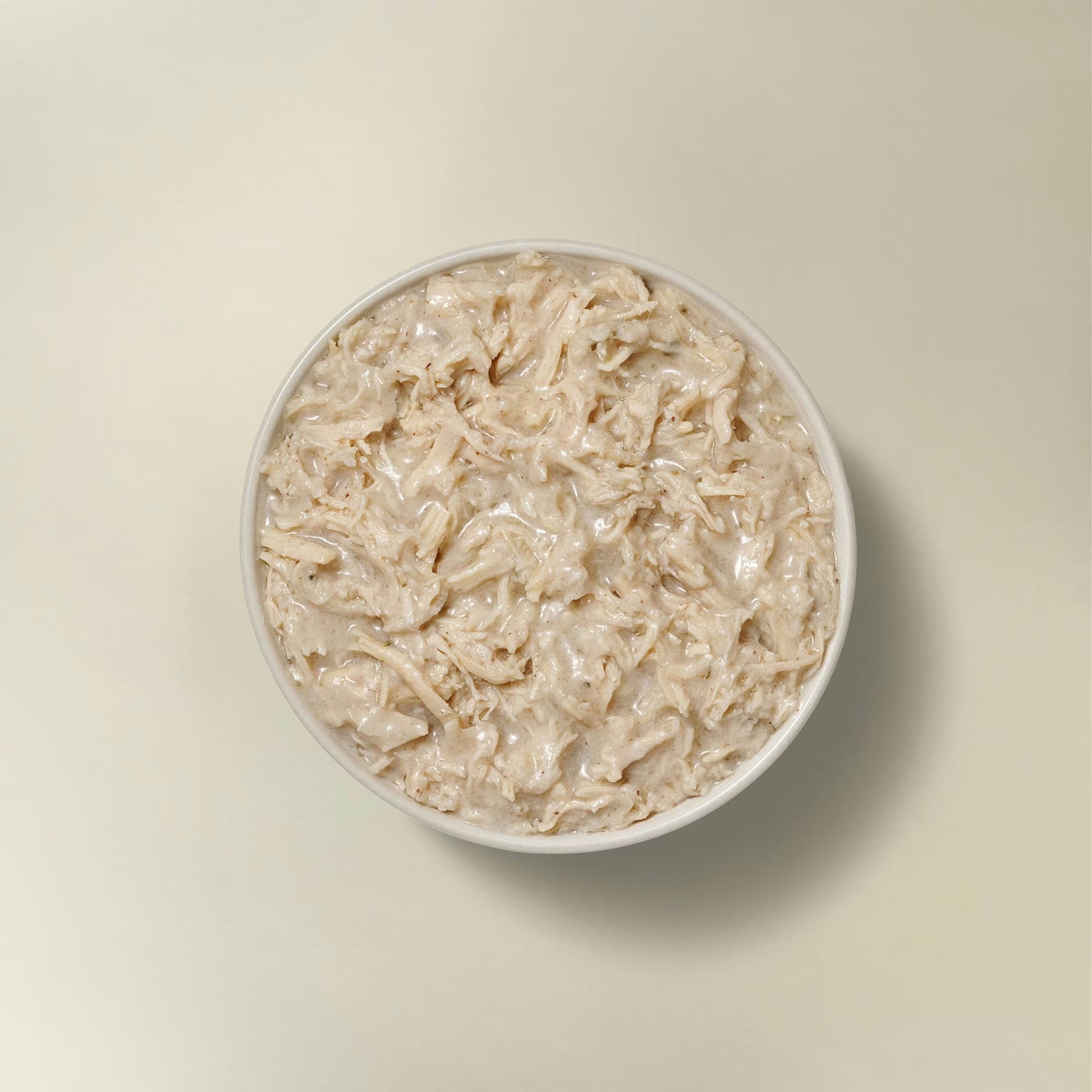 Petcurean grain free wet dog food for small breeds in a bowl with moist turkey chunks