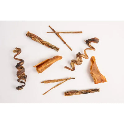 Pork dog treats variety pack featuring different shapes and textures for healthy snacking