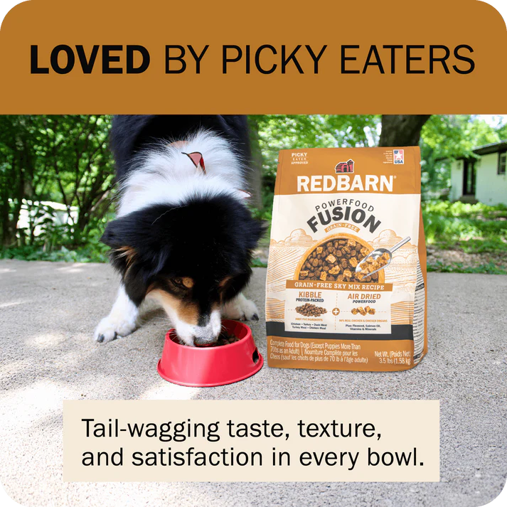 Redbarn Fusion Grain Free Dry Dog Food in a bag with a dog eating from a bowl outdoors