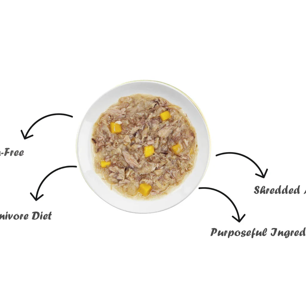 Snappy Tom tuna and egg cat topper in a white bowl with chunks of fish and fruit