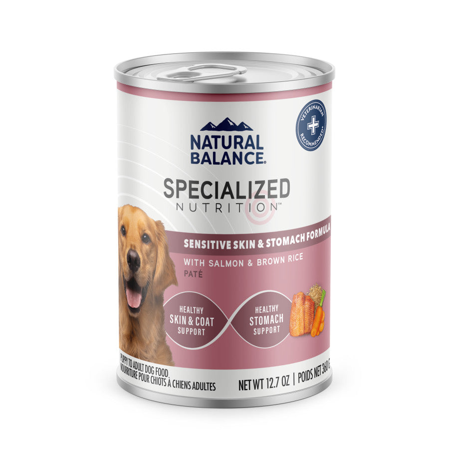 A can of Natural Balance Specialized Nutrition Sensitive Skin & Stomach Formula Adult Salmon & Brown Rice Wet Dog Food highlights Omega Fatty Acids and features images of a happy dog, salmon, and rice for skin, coat, and stomach support.