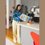 Winnie Lou air dried turkey and whitefish dog food being poured by a woman in a modern kitchen