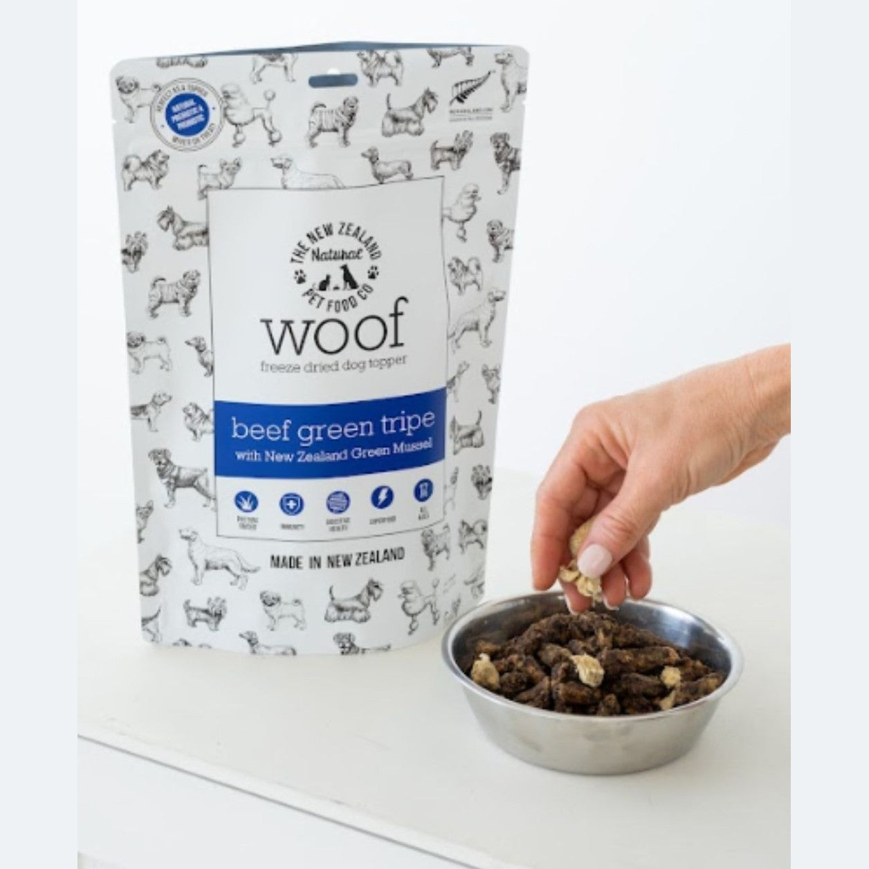 The New Zealand Natural Pet Food Co beef green tripe dog food topper being added to a bowl