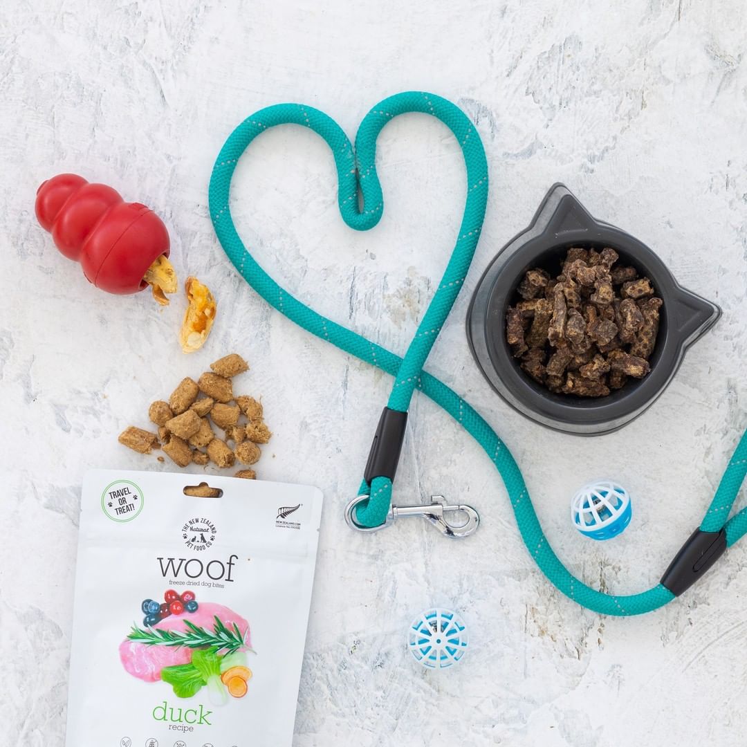 The New Zealand Natural Pet Food Co freeze dried duck dog food next to toys and a food bowl