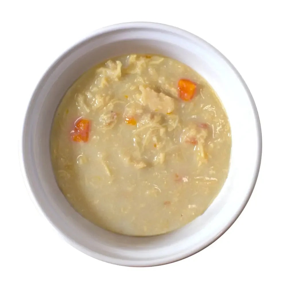 Lotus Just Juicy chicken cat food in a white bowl with vegetables for a nutritious meal